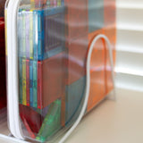 Colorful books in transparent plastic covers on a white shelf.